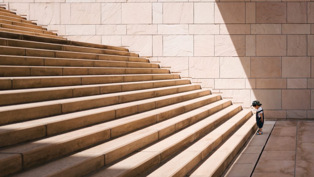 Standing at the bottom of the stairs