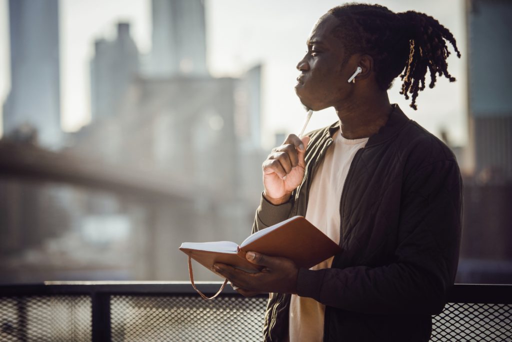 Man thinking with journal